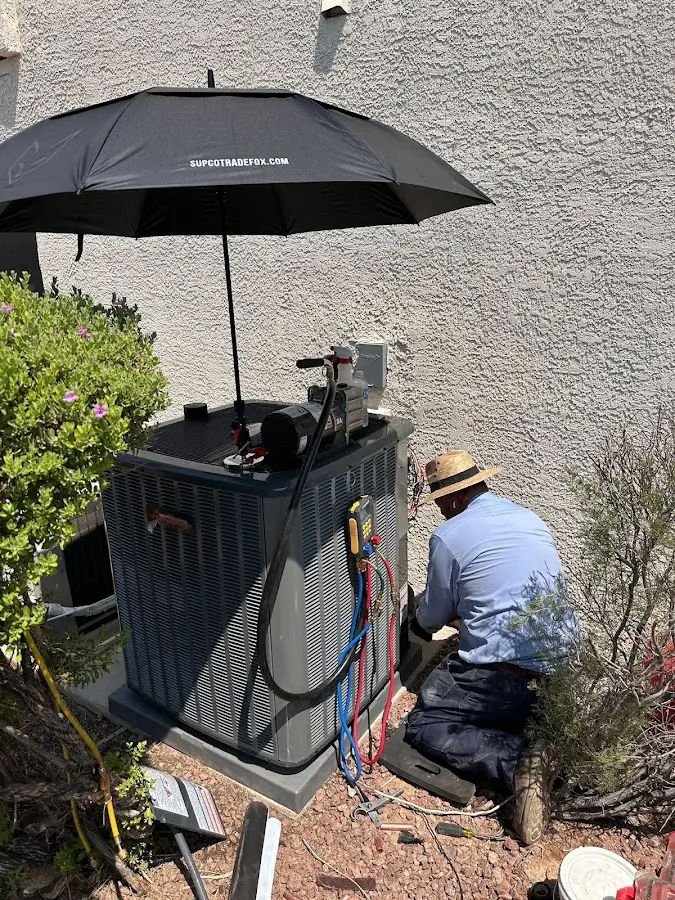 HVAC technician performing outdoor AC maintenance in Brentwood